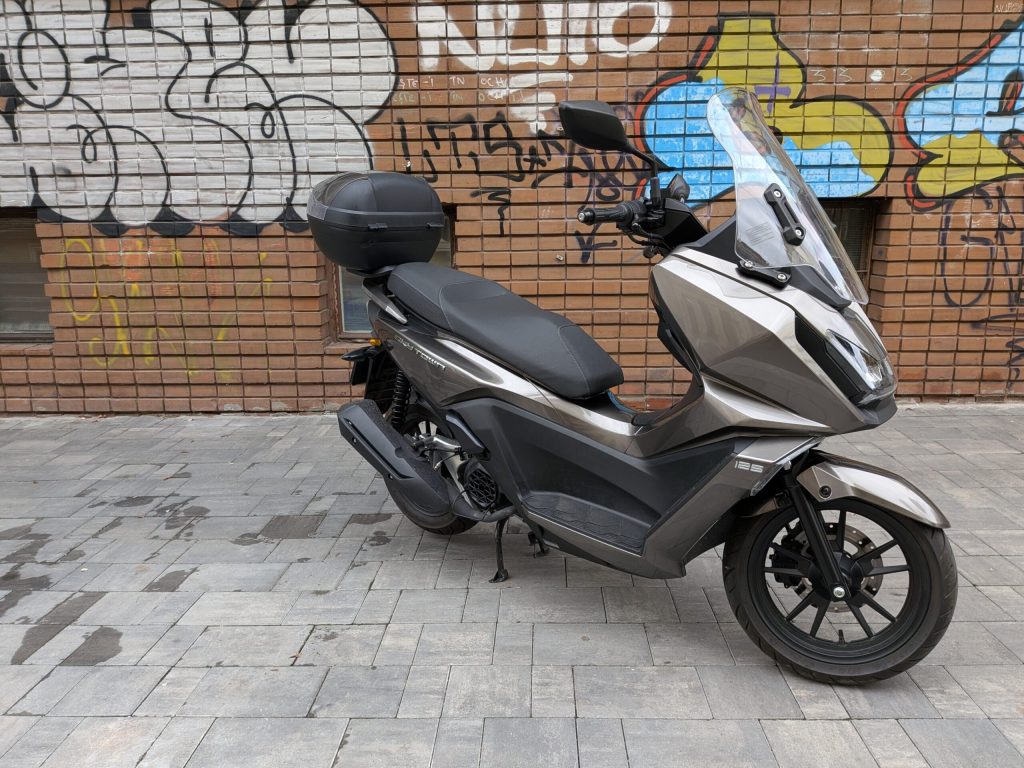 Revizuire video a modelului Kymco SkyTown 125, un scooter taiwanez cu inspirație japoneză și pe principiul funcționalitatea peste aspect, în utilizarea zilnică
