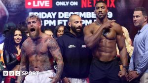 Iată o reformulare a titlului: “Jake Paul vs Anthony Joshua: Un spectacol riscant se apropie la meciul din Miami”

Sau, folosind sinonime:
“Confruntarea dintre Jake Paul și Anthony Joshua: Un risc major și un spectacol deosebit se prefigurează la lupta din Miami”

Sau, într-o variantă mai concisă:
“Jake Paul vs Anthony Joshua: Risc și spectacol la meciul din Miami”