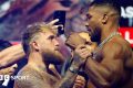 Jake Paul grabs Anthony Joshua's fist during a face-off