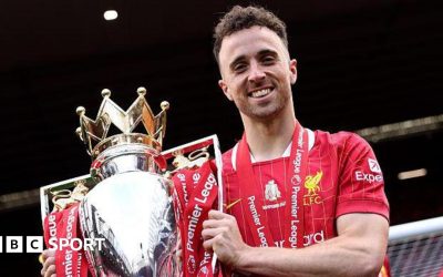 Diogo Jota holding the Premier League trophy while playing for Liverpool in May
