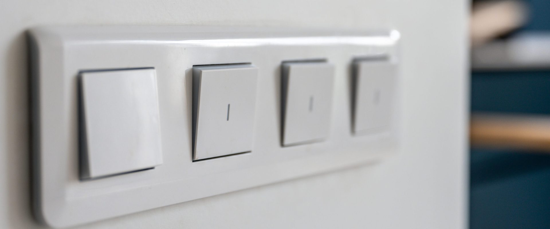 four-light-switches-macro-with-bokeh-background-minimal-design-scaled.jpg