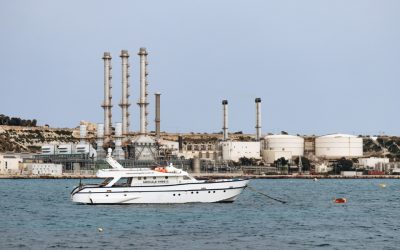 yacht-on-water-near-industrial-refinery-coastal-facility.jpg