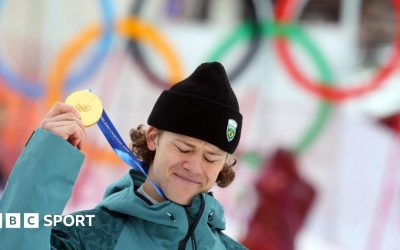 Lucas Pinheiro Braathen holds up his Olympic gold medal